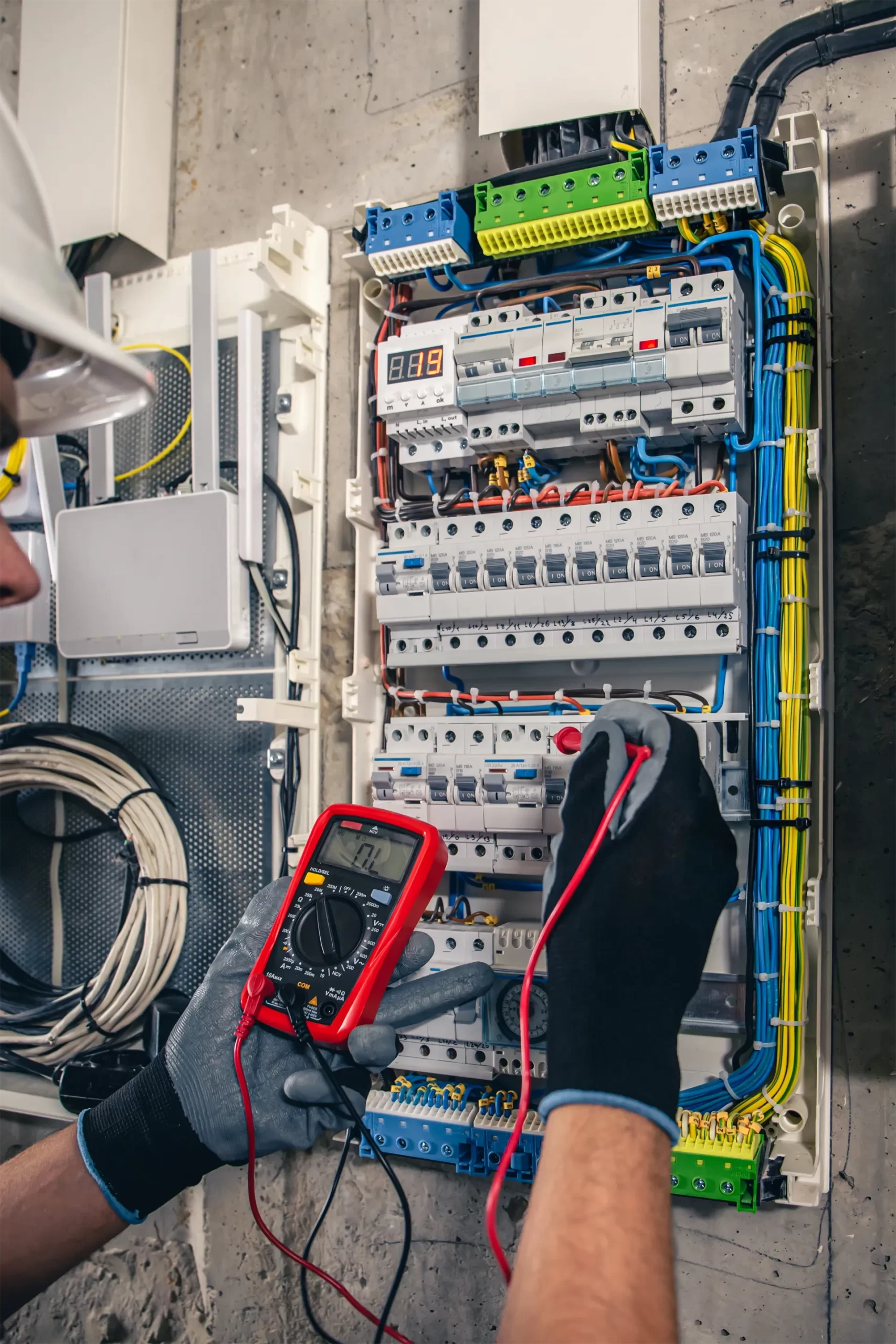 man-electrical-technician-working-switchboard-with-fuses-scaled.webp